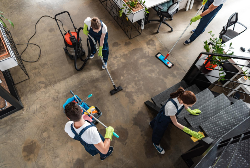 Janitorial team cleaning floors and high-touch areas in a commercial office.